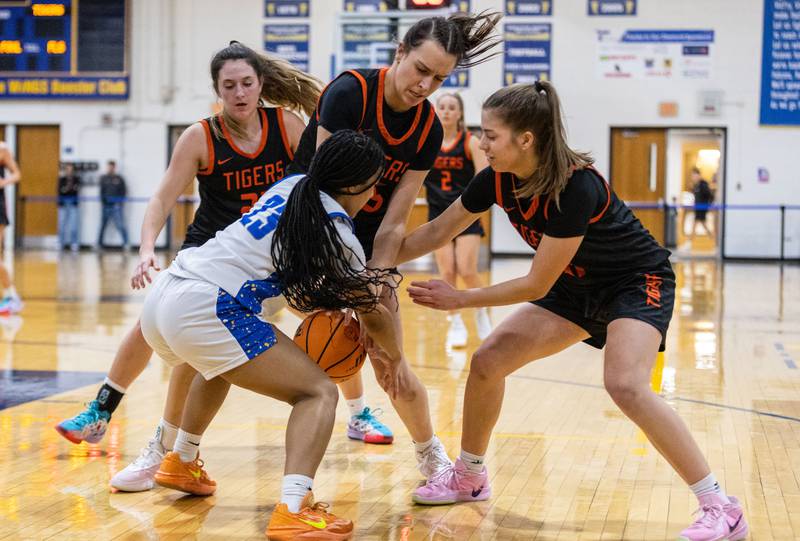 Wheaton North’s Brea Moore tries to keep the ball away from Wheaton Warrenville South during a game at Wheaton North High School on Friday, Dec. 20, 2024.