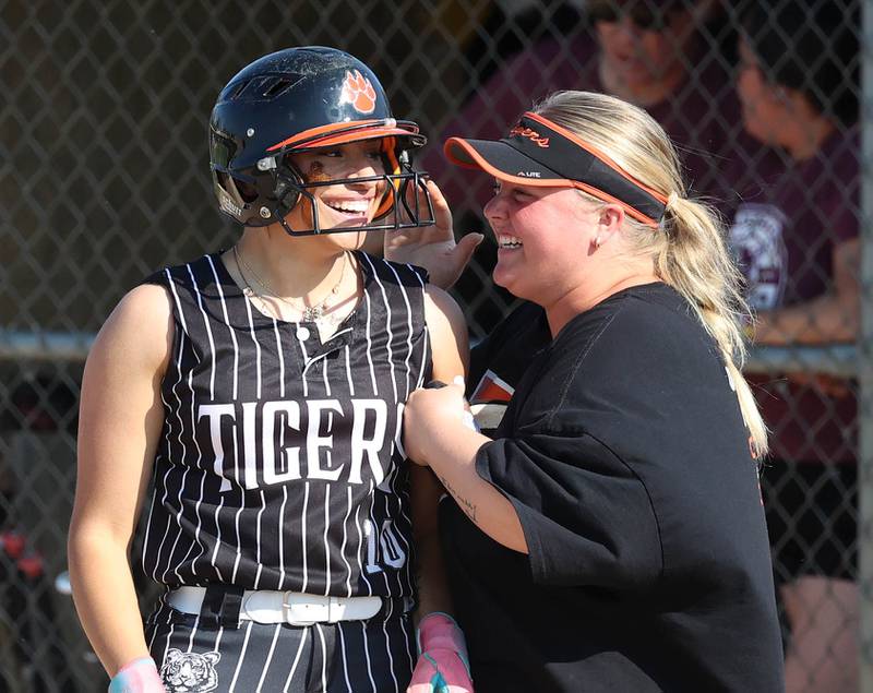 Crystal Lake Central's Liv Shaw is congratulated by her first base coach after getting a hit Friday, June 6, 2025, during their Class 3A sectional final game against Prairie Ridge at Sycamore High School.