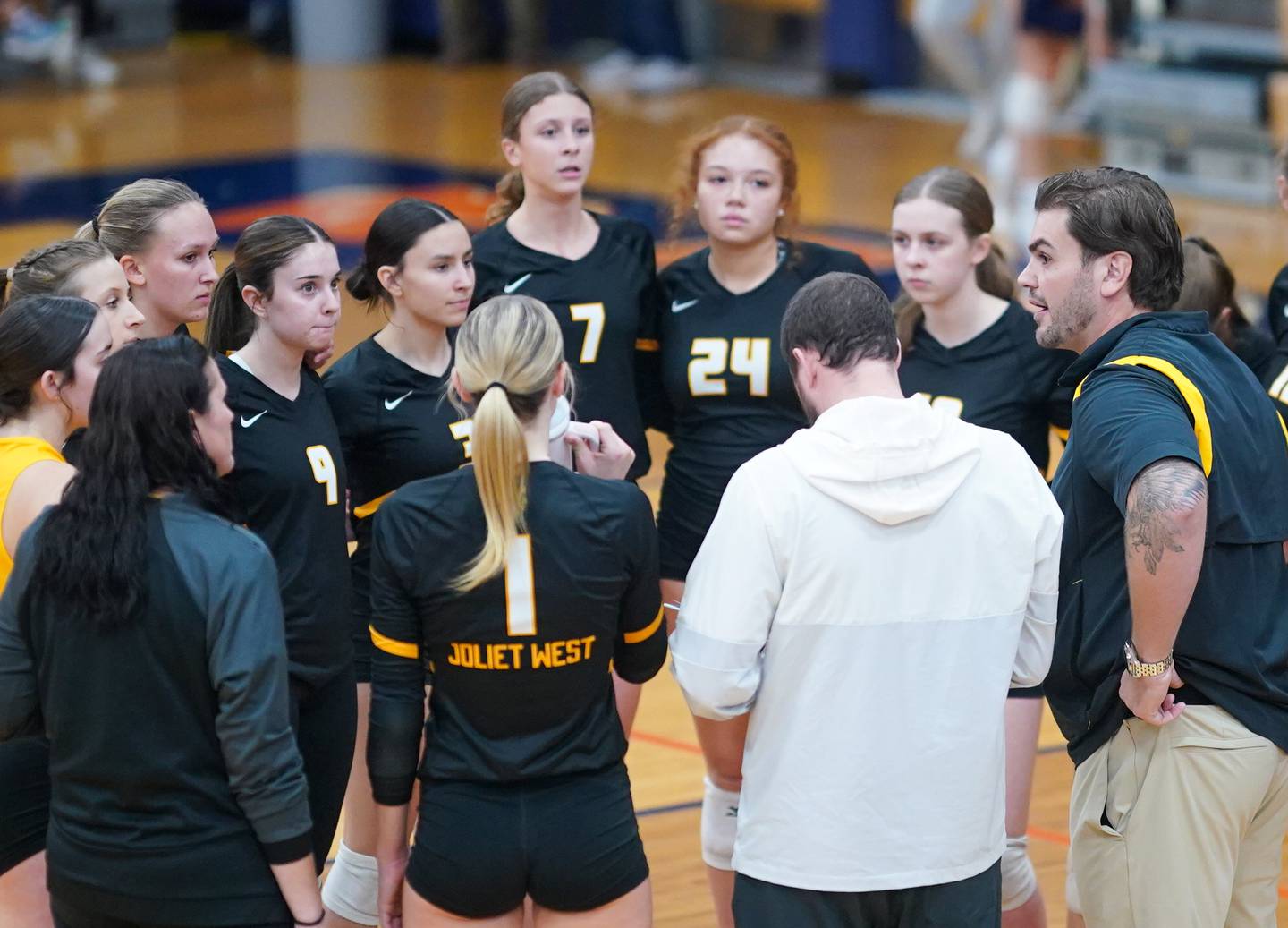 Joliet West's head coach Christopher Lincoln (right) talks to his players during a class 4A Oswego Sectional semifinal match at Oswego High School on Monday, Oct. 30, 2023.
