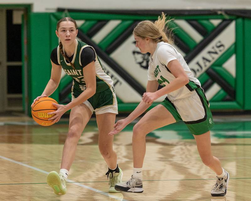 Hannah Heiberger (22) of St. Bede holds ball whilst looking for open teammate as Dwight's Addy Sulzberger (21) looks to intercept on Monday, January 19, 2026 at the Krese Memorial Gymnasium in Dwight.