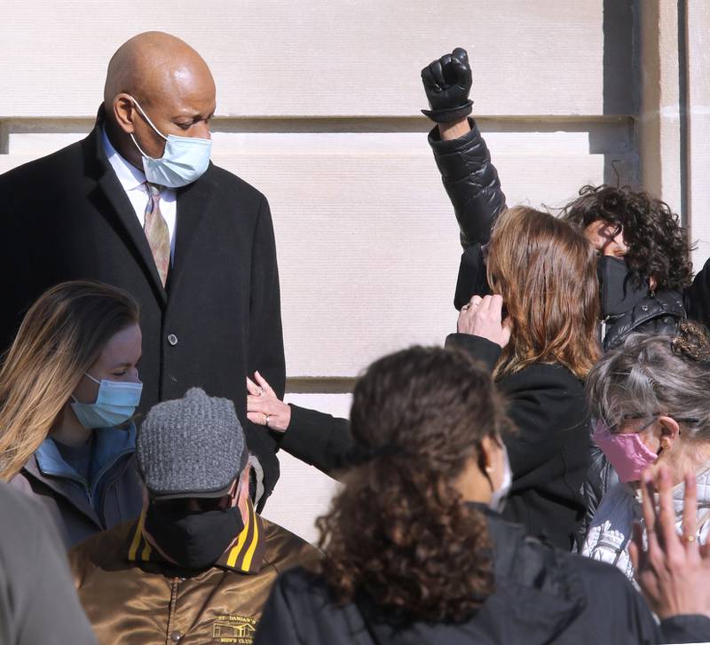 Shawn Thrower greets his wife Lorri as supporters applaud while he exits the DeKalb County Courthouse Friday after he was sentenced to 24 months court supervision, 120 hours for community restitution service, a $2,500 fine and no jail time for battering a 15-year-old female employee.
