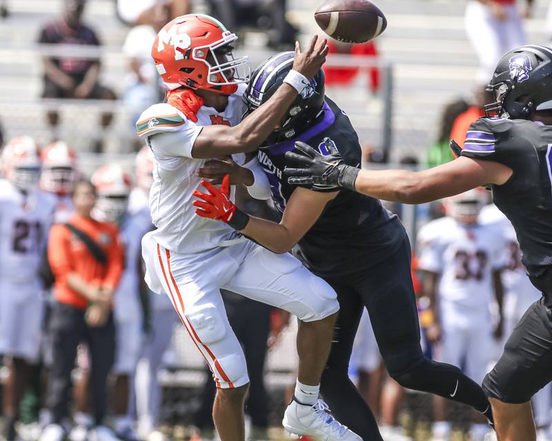 Downers Grove North's William Vala (9) chases down Morgan Park's Ronald Smith Jr. (1) for a sack during football game between Downers Grove North at Morgan Park Saturday, Aug 30, 2025  in Chicago.