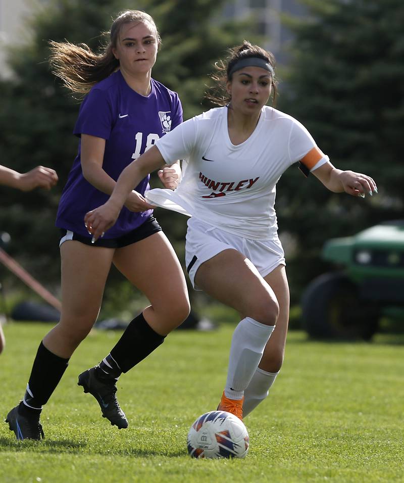 Huntley's Maddie Rumachik tries to slow down Huntley's Gabi Farraj as she goes after the ball during a Fox Valley Conference soccer game on Tuesday, April 23, 2024, at Hampshire High School.