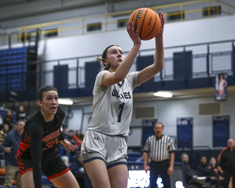 Oswego East's Aubrey Lamberti (1) goes in for a layuo during their basketball game between Minooka at Oswego East Friday, Jan 16, 2026 in Oswego.