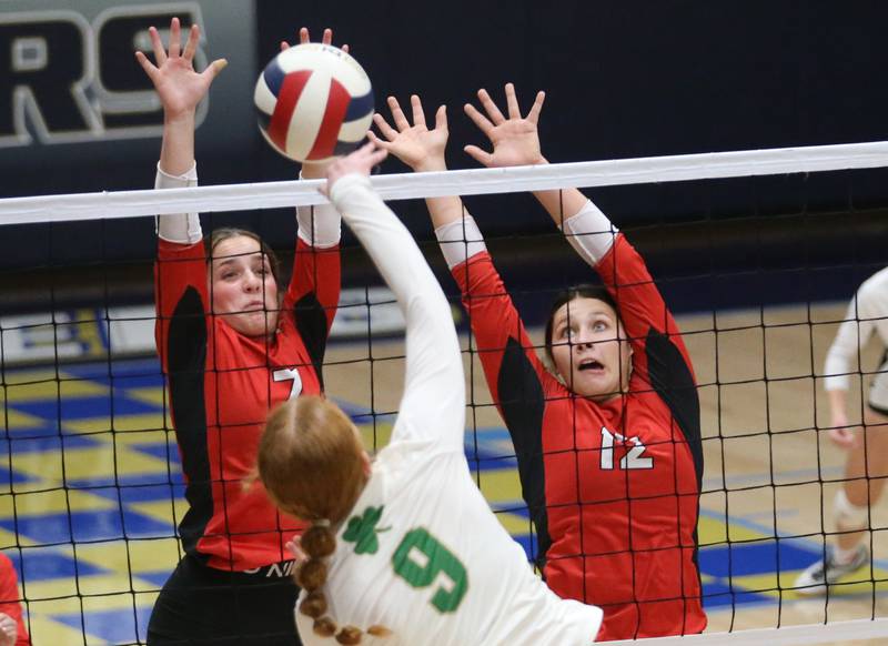 Seneca's Brooklyn Sheedy spikes the ball against Henry-Senachwine's Lauren Harbison and teammate Kaitlyn Andersonduring the Tri-County Conference Championship game on Thursday, Oct. 17, 2024 in Bader Gym at Marquette High School.