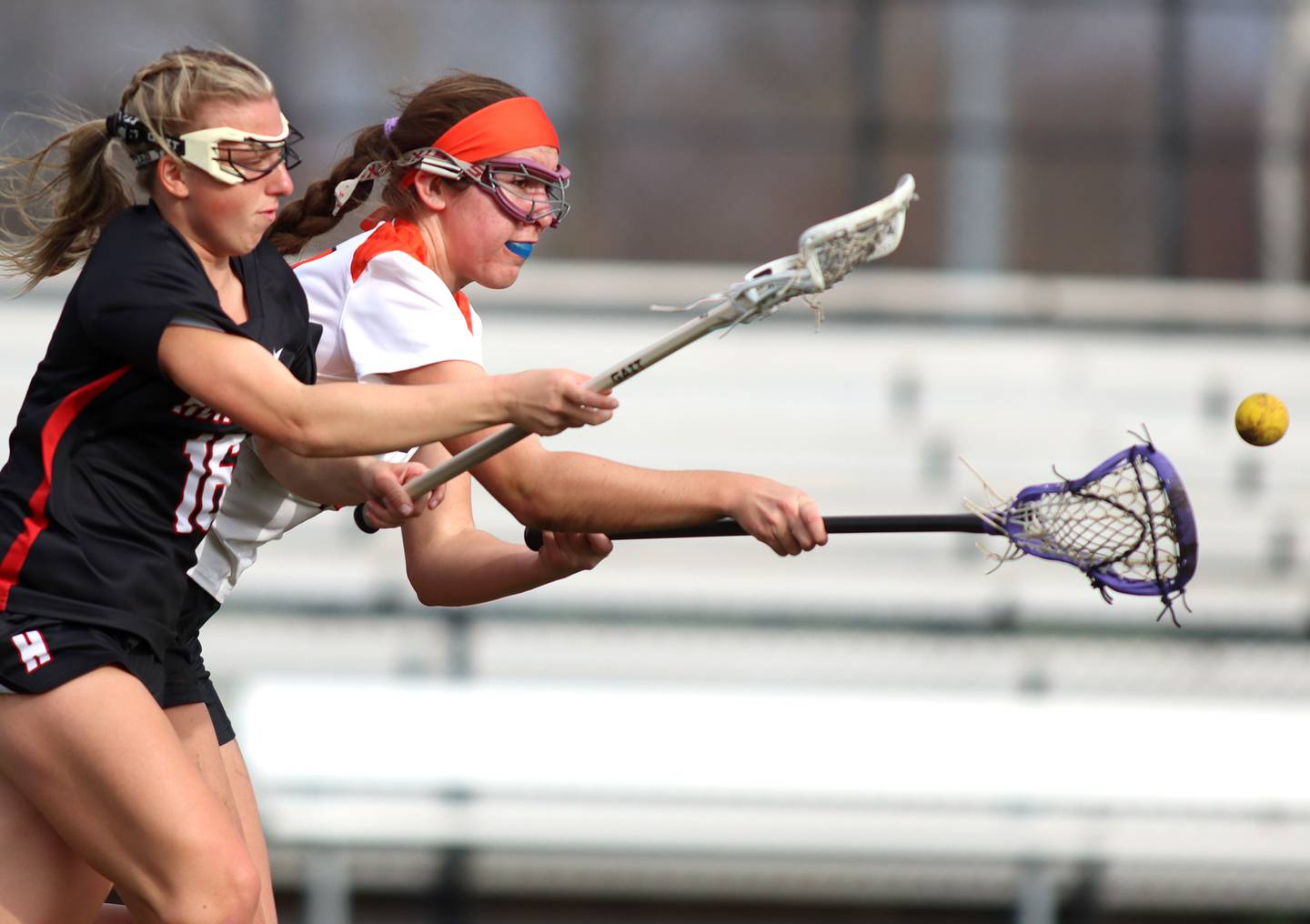 Crystal Lake co-op’s Anna Starr, back, battles Huntley’s Katie Ferrara for the ball in varsity girls lacrosse on Friday, April 18, 2025, at Metcalf Field on the campus of Crystal Lake Central High School in Crystal Lake.
