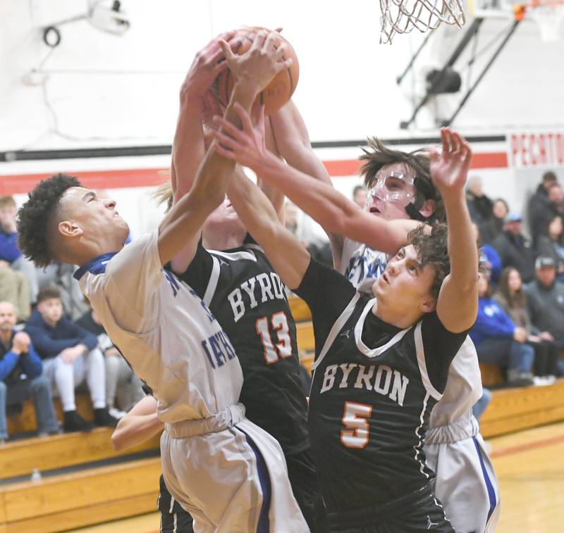 Newman's Isaiah Williams (12) and Kenny Boesen (25) battle Byron's Jack Hiveley (13) and Kye Aken (5) during Monday action at the Forreston Holiday Tournament.