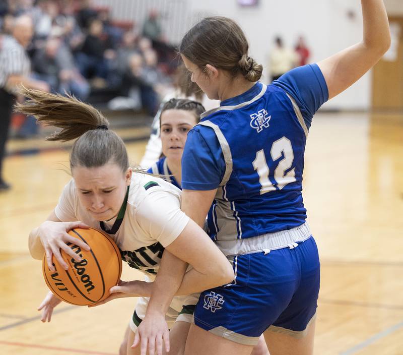 River Ridge’s Kenley Patterson grabs rebound against Newman’s Lucy Oetting Thursday, Feb. 20, 2025, during the Class 1A girls basketball regional at Forreston.