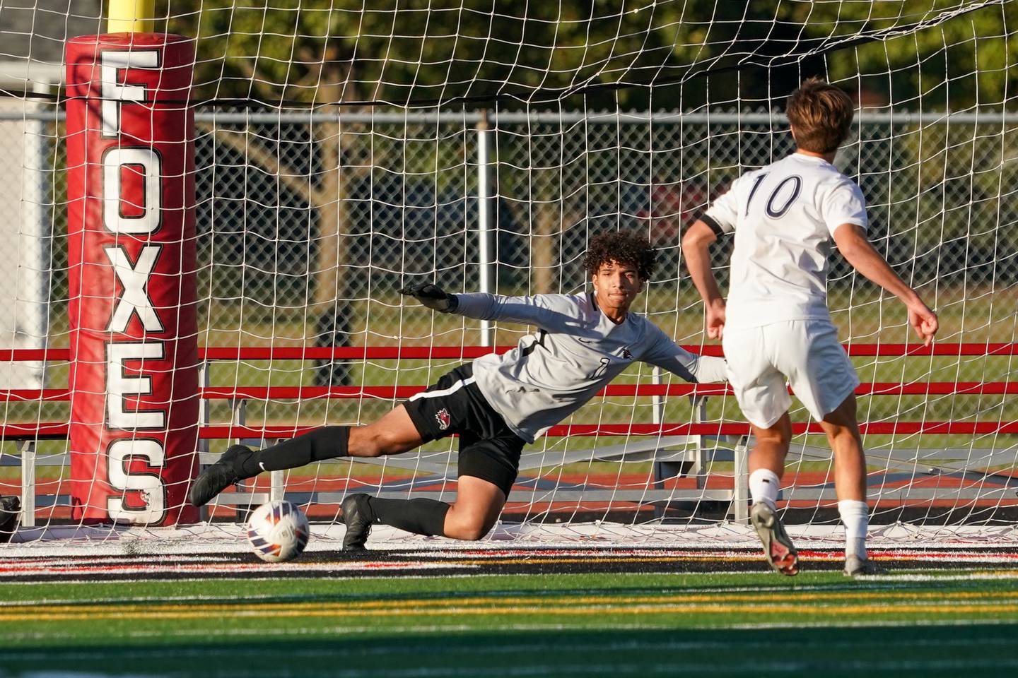 Oswego East's Dylan Drendel (10) shoots the ball past Yorkville's Caleb Reveter (1) for a goal on a penalty kick during a soccer match at Yorkville High School on Tuesday, Oct. 15, 2024.