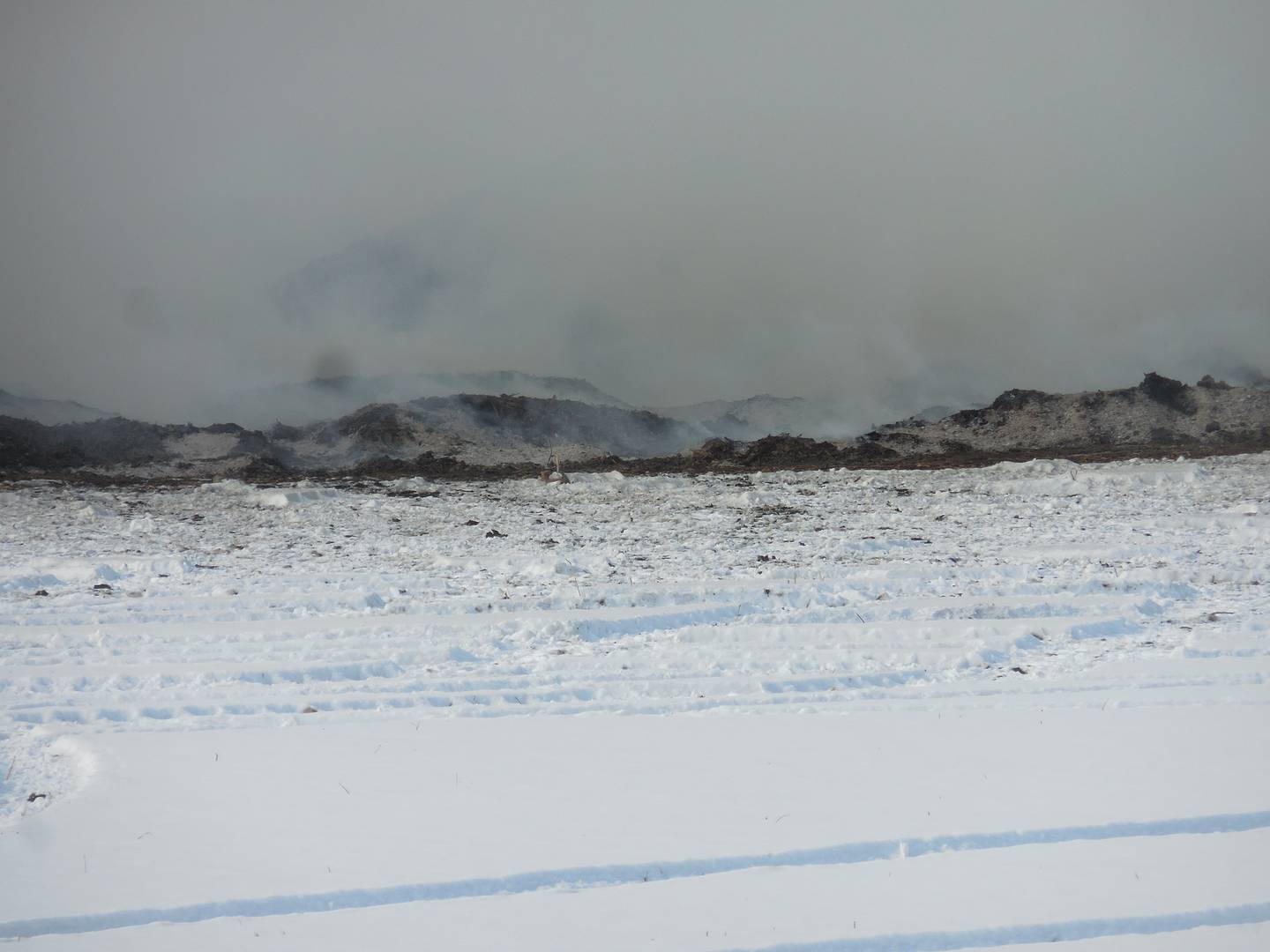 Piles of mulch that caught fire Friday were still smoldering three days later.
