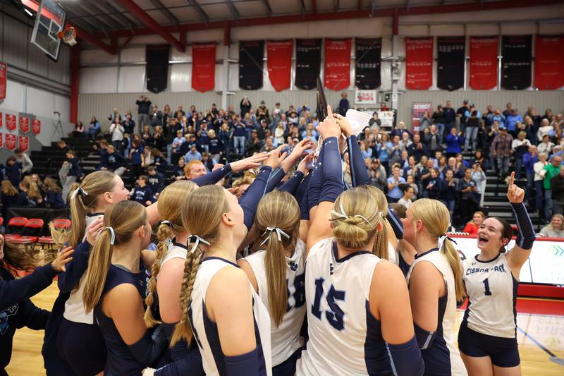 Cissna Park players hoist the IHSA Class 1A Heyworth Super-Sectional plaque following Timberwolves' victory in two sets, 25-22, 25-11, over Windsor/Stewardson-Strasburg on Monday, Nov. 10, 2025.