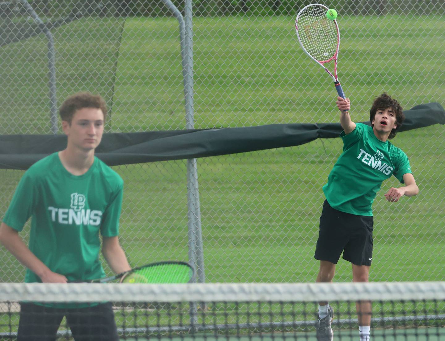 L-P's Carson Sellett and Isaac Adams play tennis on Tuesday, April 21, 2026 in the Henderson-Guenther Tennis Facility at Ottawa High School.