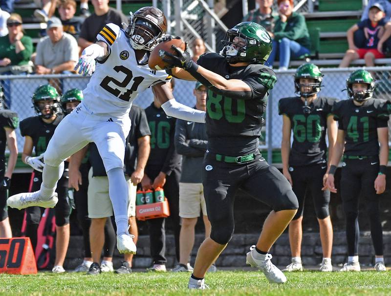 Glenbard West’s Brady Johnson (right) makes a catch in front of Joliet Catholic’s Kai Nathaniel (21) before carrying it for a long touchdown run during a game on September 6, 2025 at Glenbard West High School in Glen Ellyn.