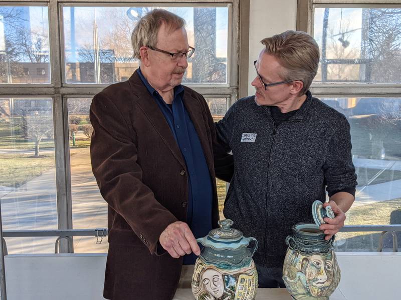 Retired art teacher Robert Wilson, left, and St. Charles East High art teacher Gregory Chapman, right, on Sunday were at a reception for their art exhibit at Marmion Academy in Aurora.