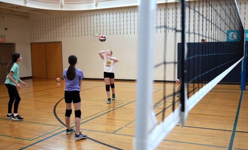 (From left) Alexis Menapace, 11, Grace Ginex, 11, and Allie Reetz, 11, play volleyball during the Middle School Gym Jam at the Downers Grove Park District Recreation Center on Thursday, Jan. 4, 2024.
