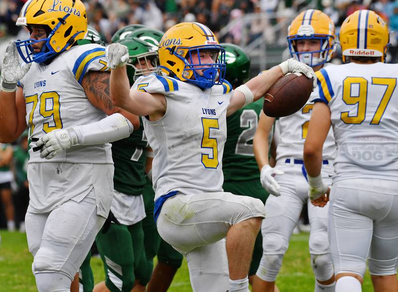 Lyons Township's Danny Caroll  (5) celebrates after scoring a touchdown against Glenbard West during a game on Sep. 16, 2023 at Glenbard West High School in Glen Ellyn.