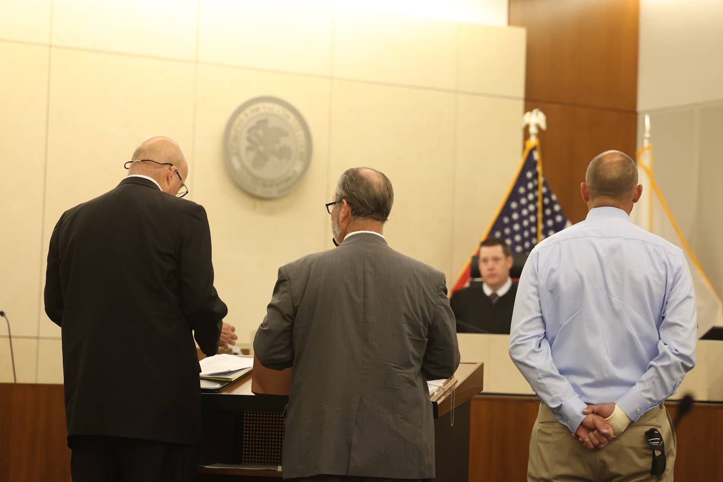 Prosecuting attorney Bill Elward, left, defense attorney Robert Bodach and his client Edward Goewey meet with Judge Brian Barrett during a pretrial meeting. Goewey, a Will County Deputy, is on trial for disorderly conduct after he allegedly yelled at school officials and threatened to personally remove a child believed to have made a threat to shoot students at St. Mary Catholic School in Modena. Tuesday, Aug. 9, 2022, in Joliet.