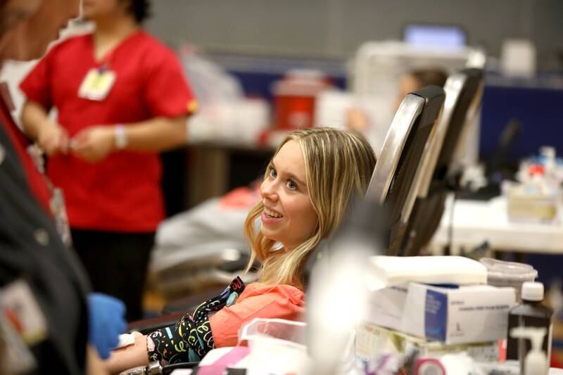 Geneva High School junior Maggie Tweed donates blood during a visit by Versiti blood donation center as part of the school’s Week of Giving on Wednesday, April 24, 2024.