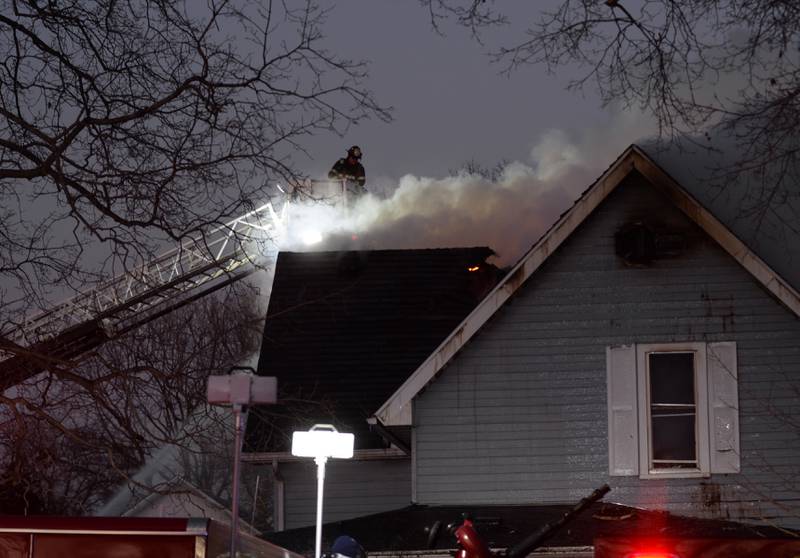 A firefighter from Sterling sprays water on a burning home at 5500 Mill St. in Emerson on Sunday, Jan. 19, 2025. Fire crews from many area departments responded to the scene transporting water to fight the blaze for several hours in frigid temperatures.