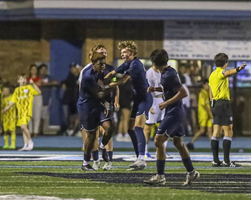 Downers Grove South's Zeke Hall-Taylor (18) celebrates his goal with teammates during soccer match between Downers Grove North at Downers Grove South. Oct 2, 2025.