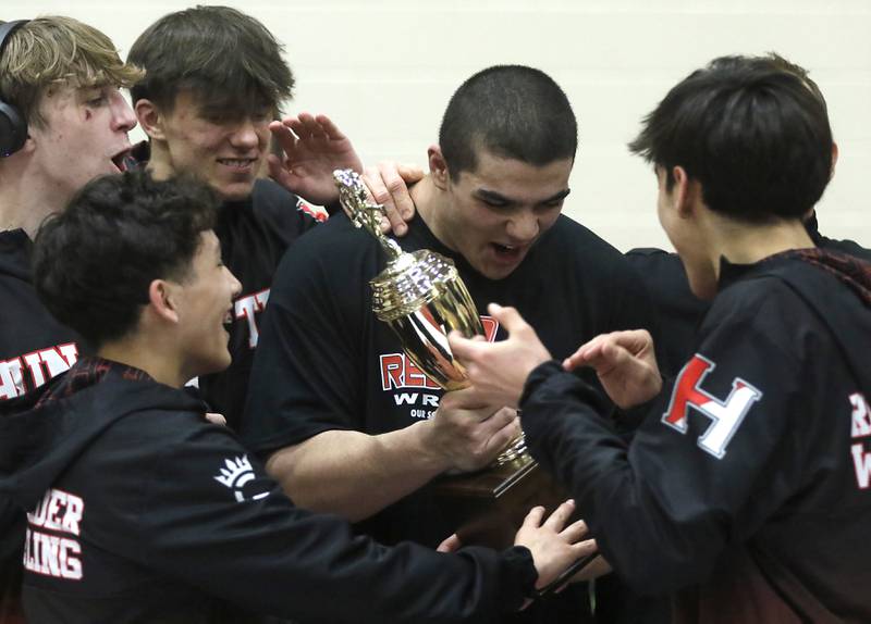Huntley’s Markos Mihalopolus holds the Foxx Fox Valley Conference wrestling trophy after Huntley defeated Hampshire to win the conference on Wednesday, Jan. 24, 2024, at Huntley High School.