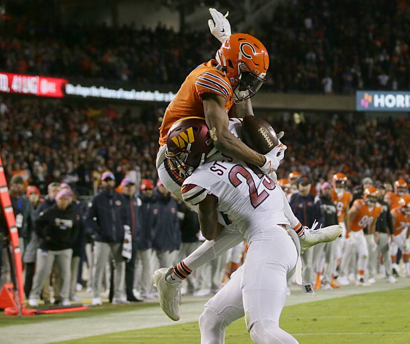 Chicago Bears wide receiver Darnell Mooney (11) fails to score a touchdown on this catch late in the fourth quarter as Washington Commanders corner back Benjamin St.-Juste makes the tackle on Thursday, Oct. 13, 2022 at Soldier Field.