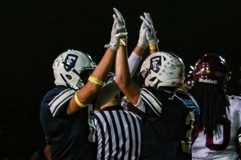 Eddie Lorton and Drew Overocker of Fieldcrest celebrate with a high-five on Friday, September 20, 2024 at Fieldcrest high school in Minonk.
