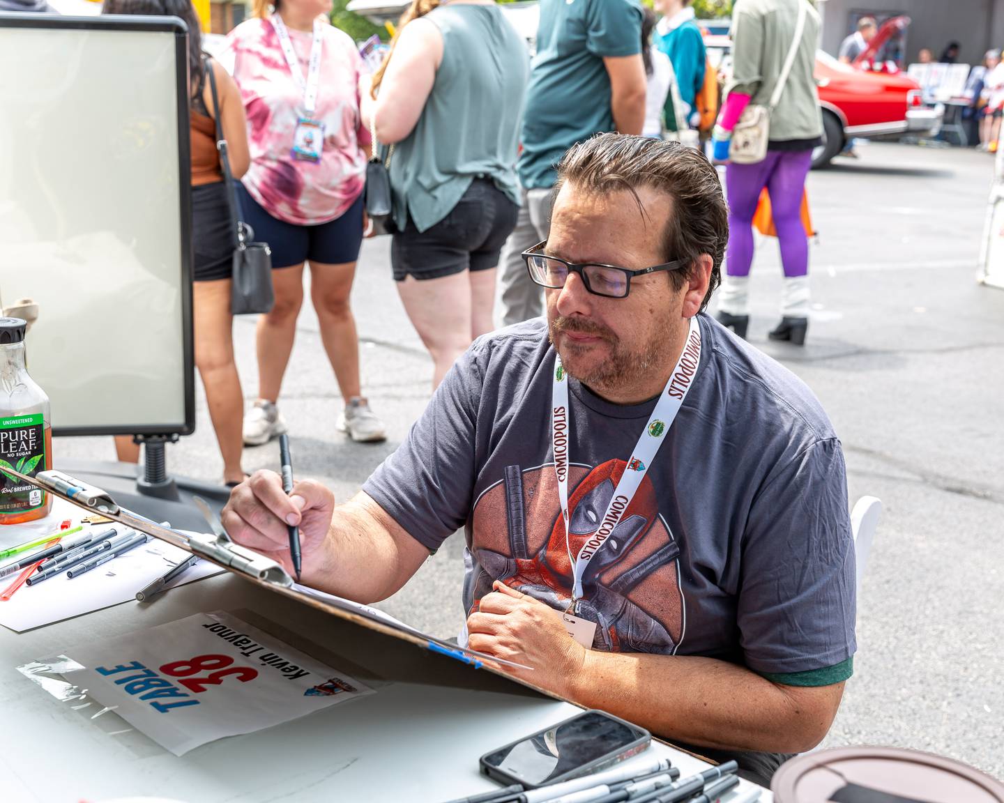 Local Lockport artist Kevin Traynor sketches a caricature at the Lockport Comicopolis July 20th, 2024.