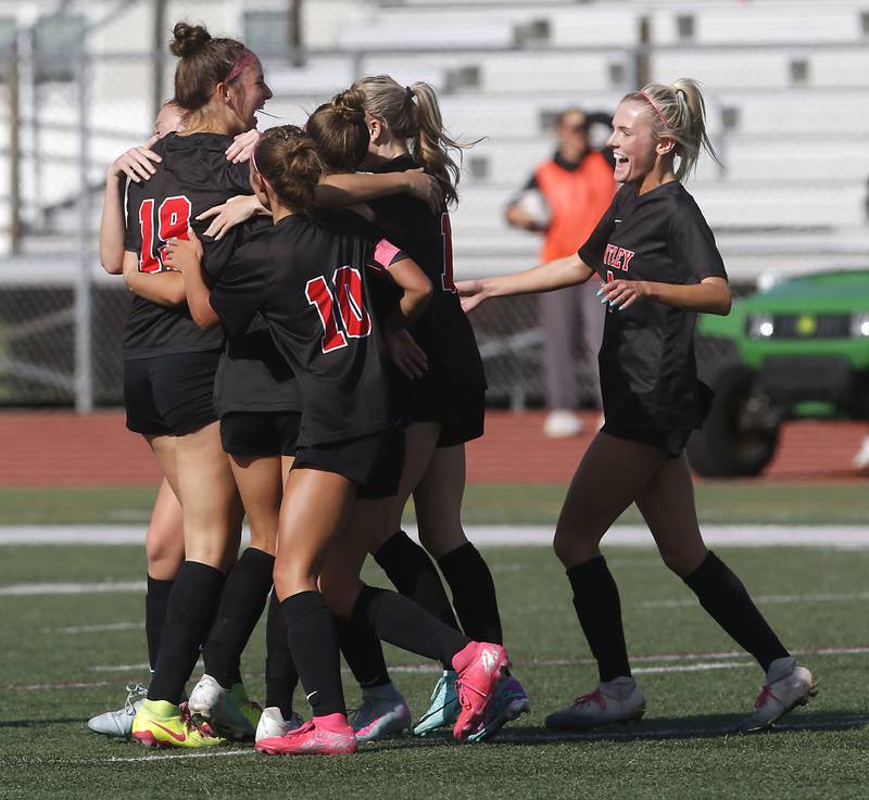 Huntley's Jaci Laramie (left) is mugged by her teammates after scoring Huntley’s first goal on a free kick during the IHSA Class 3A Huntley Girls Soccer Regional championship match against Jacobs  on Friday, May 23, 2025, at Huntley High School.