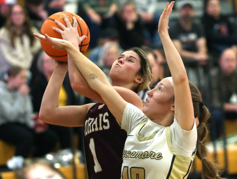 Morris' Cami Pfeifer tries to get a shot up over Sycamore's Cortni Kruizenga during their game Tuesday, Jan. 13, 2026, at Sycamore High School.