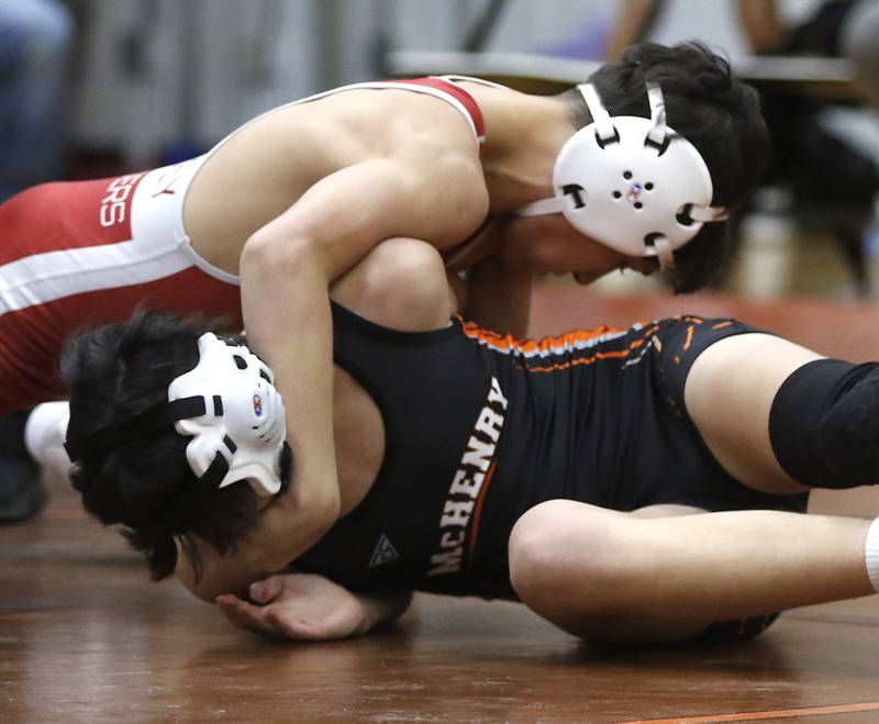 Huntley’s Cameron Collin Abordo controls McHenry’s Tennyson Gordillo during the 106-pound match of a Fox Valley Conference boys wrestling match Thursday, Jan. 11, 2024, at McHenry High School.
