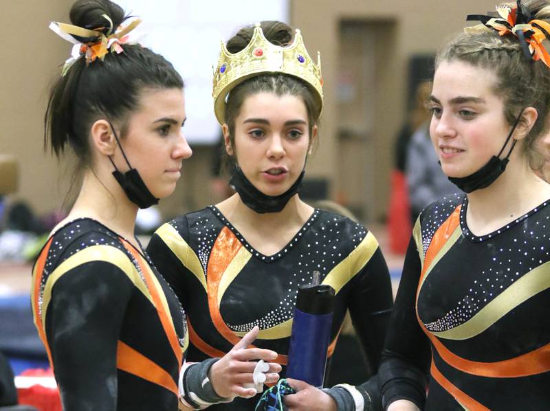 DeKalb-Sycamore gymnast Maddy Kees talks to teammates after a solid routine on the uneven bars during a meet Friday, Dec. 10, 2021, at DeKalb High School.