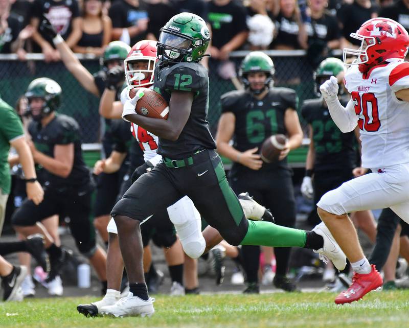 Glenbard West's Teyoin Oriental (12) breaks away for a big gain during a game against Marist on Aug. 26, 2023 at Glenbard West High School in Glen Ellyn.