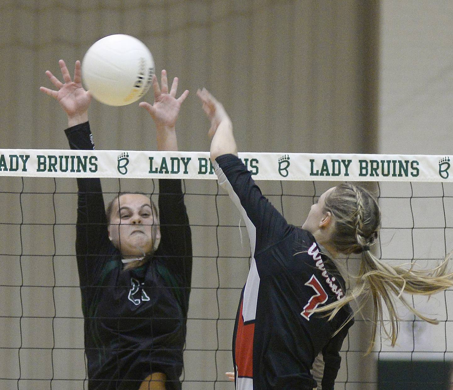 St. Bede's Johnna Bogatitus rises to block Woodland's Cloee Johnston at the net Tuesday, Oct. 25, 2022, during the quarterfinals of the Class 1A St. Bede Regional.