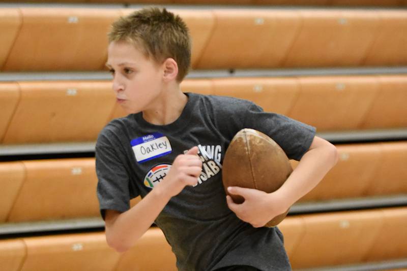 Oakley Price runs the ball during Watseka's Tackling Disabilities football camp Saturday, July 26, 2025.