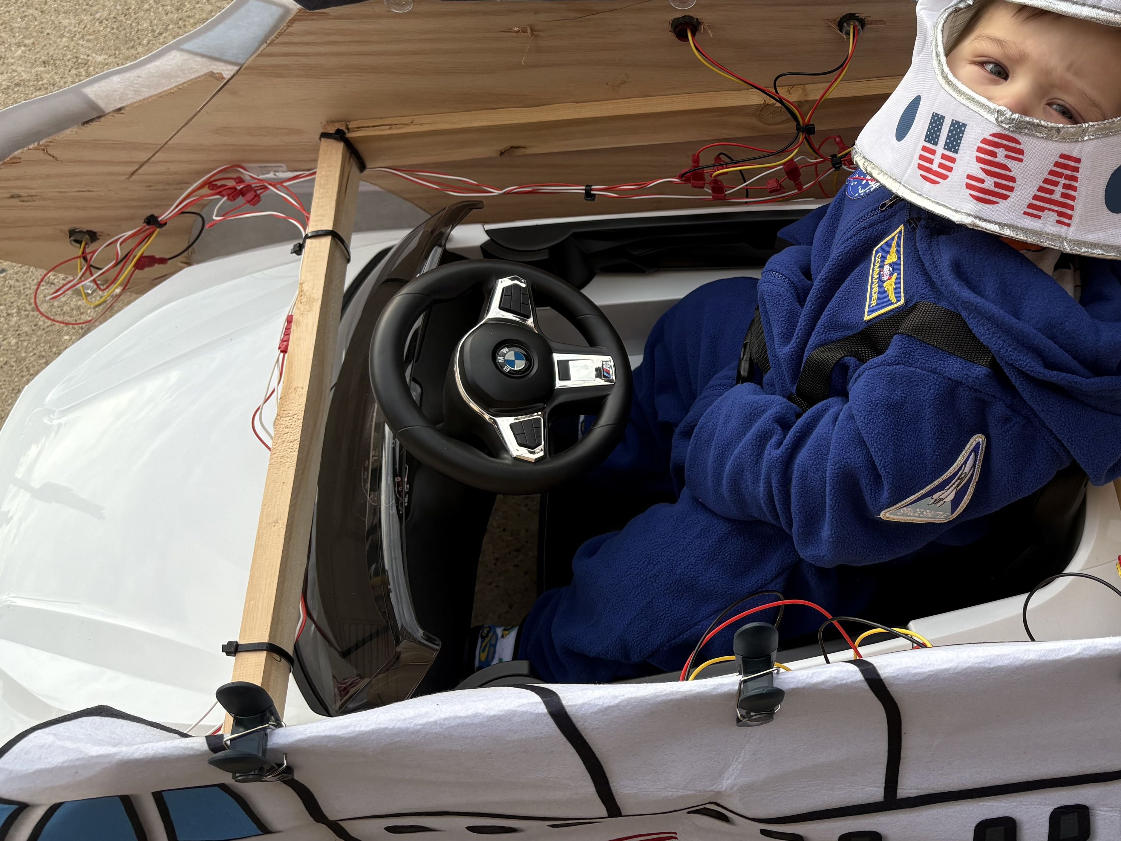 Lorenzo Barcena, 10 months, of Woodstock is pushed around in his astronaut costume during Halloween on the Square in Woodstock Oct. 31, 2025.