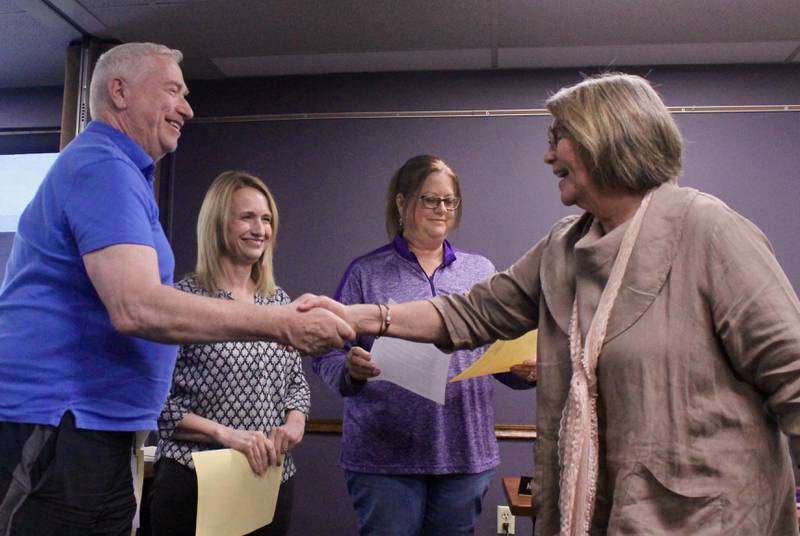 David Fritts shakes the hands of Dixon Public Schools board President Liinda Wegner after taking the oath of office on Wednesday, May 10, 2023. Fritts, Kathleen Schaefer and Melissa Gates were top-vote getters during the April 4 consolidated election and were seated during the meeting.