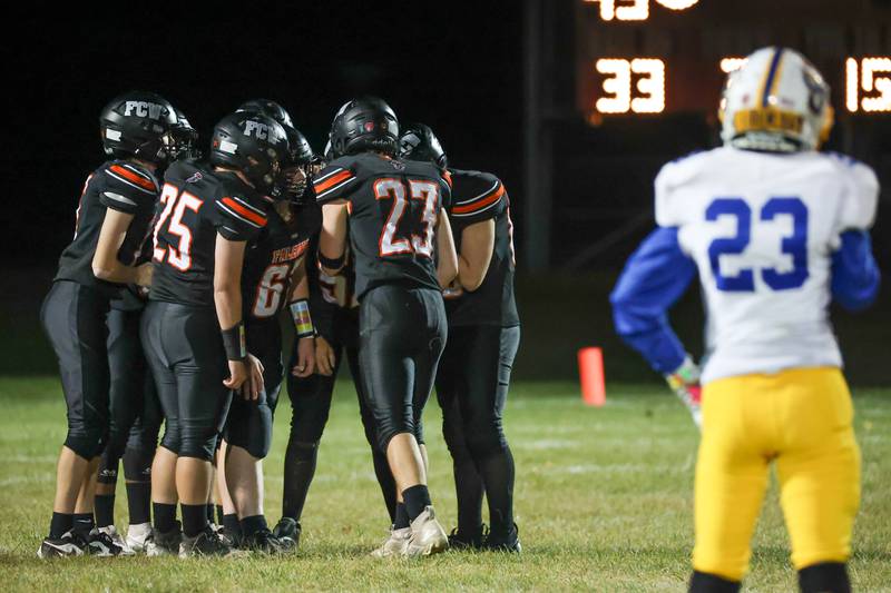 Alec Gustafson of Galva watches on as players of Flanagan Cornell Woodland huddle before play on Friday, October 25, 2024 at Flanagan High School in Flanagan.