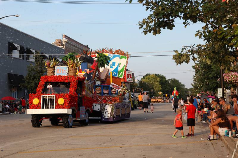 Bubbles are released from the Meyer family float, decorated on the theme of Gladiolus Game Night, during the 87th Momence Gladiolus Festival Main Street Parade on Friday, Aug. 8, 2025.