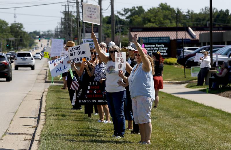 Protesters line Route 31 in front of the McHenry Public Library on Friday, June 20, 2025, during a Save Our Libraries Protest hosted by Indivisible McHenry County to draw attention to cuts to the nation’s libraries by the Trump administration.