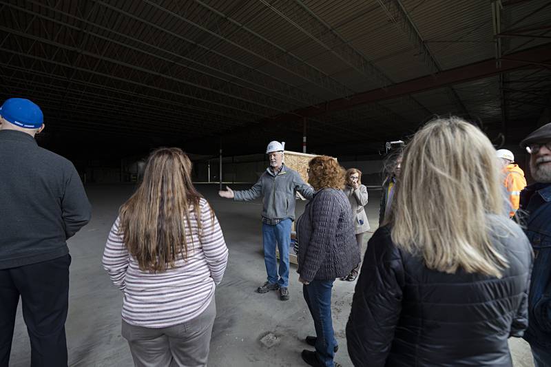 General contractor Dave Draker of Innovative Construction Solutions talks to local representatives about the space in the former Kmart building in Sterling on April 4, 2023.