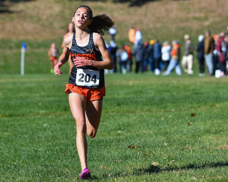 Crystal Lake Central's Hadley Ferrero heads for the finish line to finish second in the Fox Valley Conference girls cross country meet at Veteran Acres Park on Saturday, Oct. 15, 2022 in Crystal Lake.