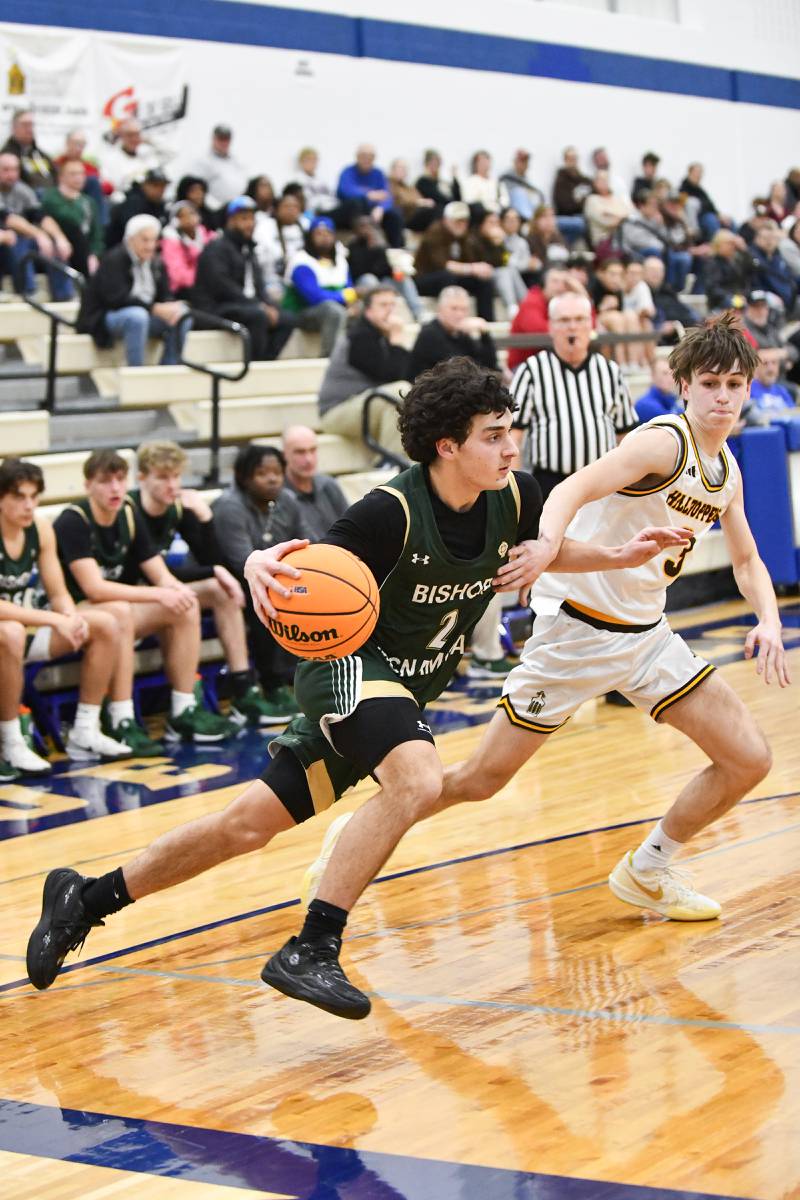 Bishop McNamara's Cole Czako drives against Joliet Catholic Academy's Connor Louthan during the Fightin' Irish's 79-67 victory over the Hilltoppers in the IHSA Class 2A Peotone Sectional semifinal on March 4, 2025.