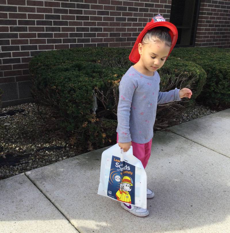 Children were treated to fire hats and educational materials Wednesday, April 10, 2024, during the Ottawa firefighters visit to the Reddick Library to celebrate National Library Week.