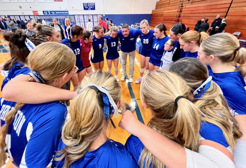 Princeton coach Andy Puck heads a happy huddle after the Tigresses captured the regional championship Thursday night, defeating Sterling Newman.