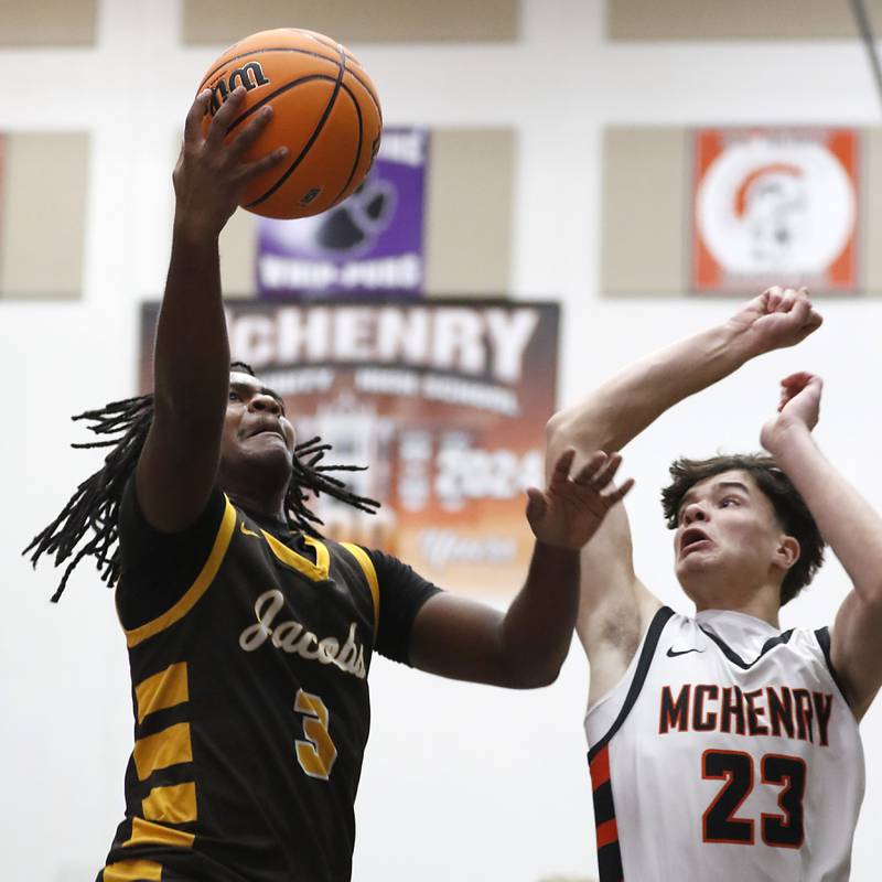 Jacobs' Emaan Thomas drives to th4 basket against McHenry's Marko Stojich during an IHSA Class 4A McHenry Regional basketball game on Wednesday, Feb. 26, 2025, at McHenry High School.