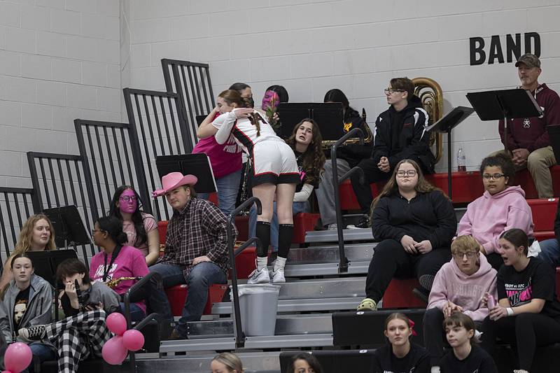 Amboy’s Jillian Anderson delivers a rose to a cancer survivor Tuesday, Jan. 27, 2026, during the Pink Out game in Amboy.