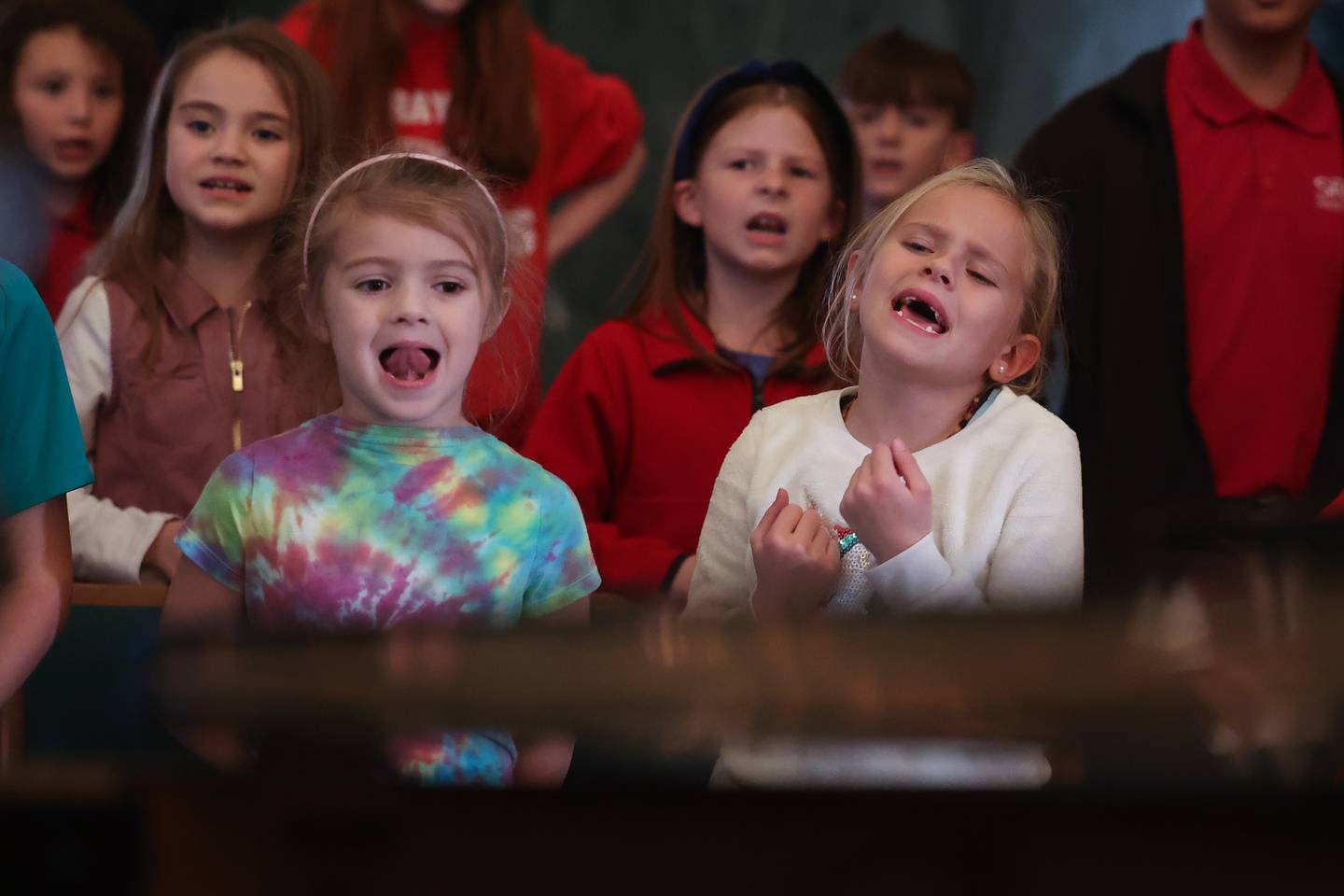 Claire Kinsella, left, and Lucy McDermott sing at the children’s choir rehearsal at the Cathedral of Saint Raymond Nonnatus for the upcoming A Very Rialto Christmas show.