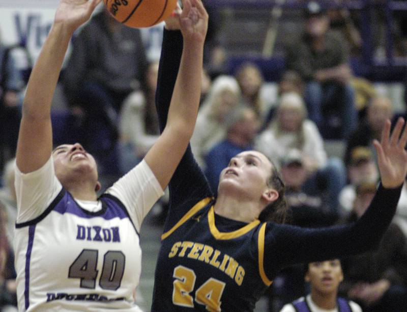 Dixon's Hallie Williamson and Sterlings Madison Austin battle for a rebound. Dixon and Sterling girls basketball teams played in the 3rd place game of the Dixon Girls KSB Holiday Basketball Classic Saturday, Dec. 28, 2024.