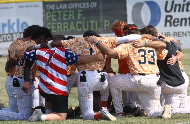 Members of the Illinois Valley Pistol Shrimp circle up before game honoring Veterans on Thursday, July 3, 2025 at Schweickert Stadium in Peru.